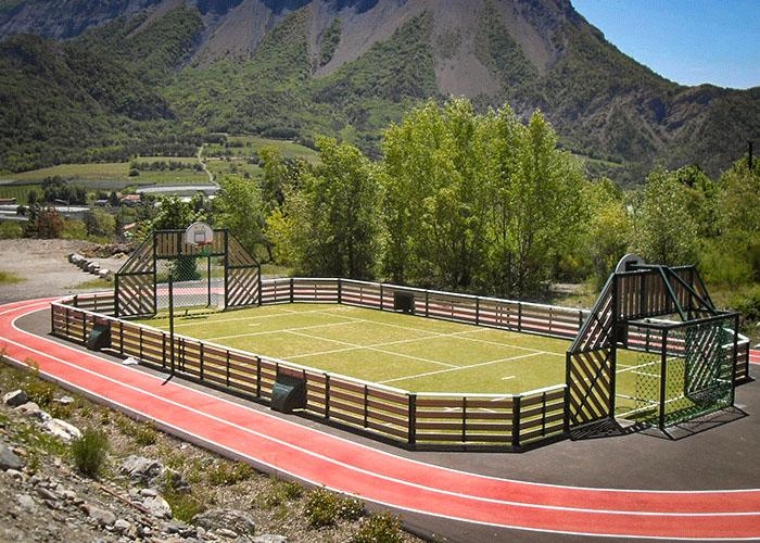 grass sports court with a track around it