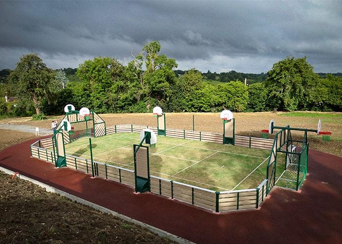 grass sports court with a track around it