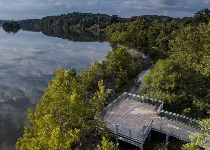 a boardwalk pier by a lake