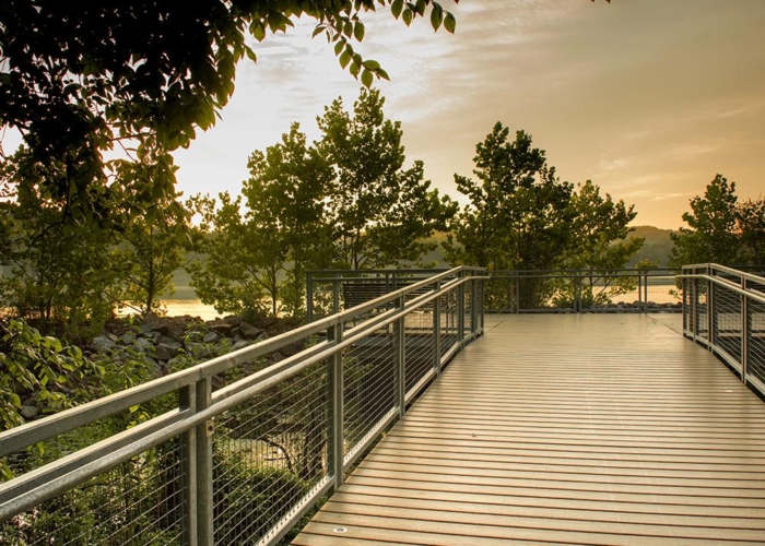 a boardwalk pier by a lake
