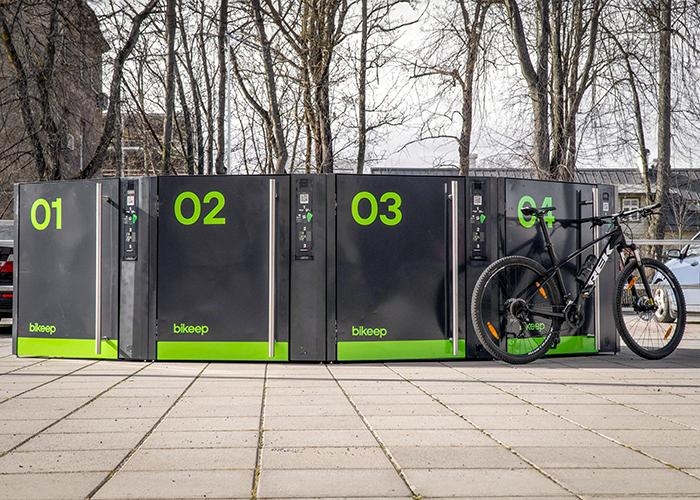 outdoor bike lockers with bike leaned against them