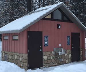 washroom building with Board and batt upper walls, napa valley rock lower walls with cedar shake roof