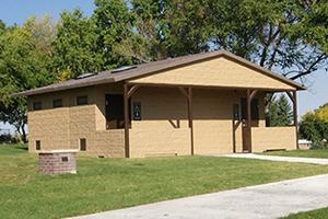 washroom building with Horizontal lap upper walls, cedar shake roof and porch