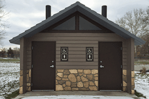 washroom building with Board and batt upper walls, napa valley rock lower walls with cedar shake roof