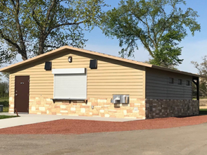 concession building with Horizontal lap upper walls, custom rock texture lower walls with cedar shake roof