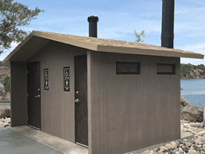 washroom building with Board and batt walls with cedar shake roof
