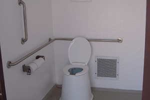 washroom building with Board and batt upper walls, napa valley rock lower walls with cedar shake roof